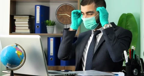 Man taking off the protective mask at office Stock Footage 133350337