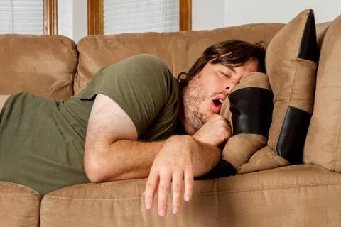 Man taking a quick nap on the couch Stock Photos