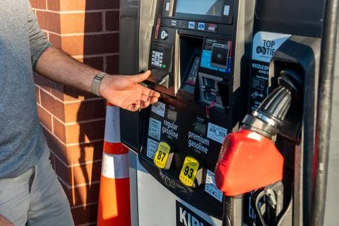Man taking a receipt from a gas pump Stock Photos