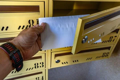 Man Taking a Registered Letter from Mailbox, Legal Notice or Court Summons Stock Photos