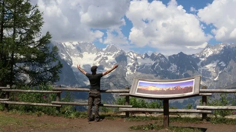 Man taking a relaxing deep breathing in front a great panorama in alps mountain Video stock 96331938