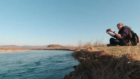 Man Taking A Selfie And River Slow Motion Stock Footage 191083523