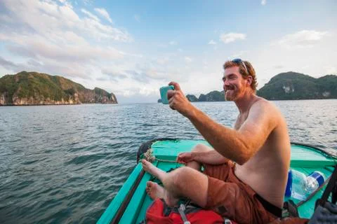 Man taking selfie on a boat at Halong Bay in Vietnam Stock Photos