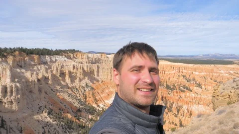 A Man Taking Selfie On The Bryce Canyon Rocks Background Video stock 88995438