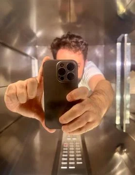 Man taking selfie in elevator Stock Photos
