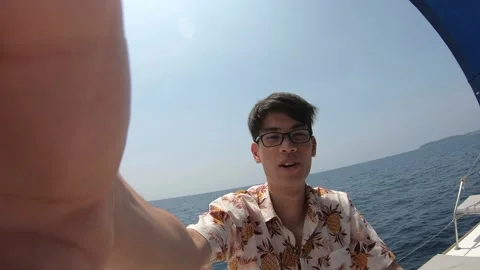 A man is taking a selfie in the ocean with his hand on his face Stock Footage 314456360