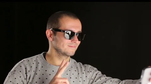 Man taking selfie with smartphone in studio 動画素材 82919960