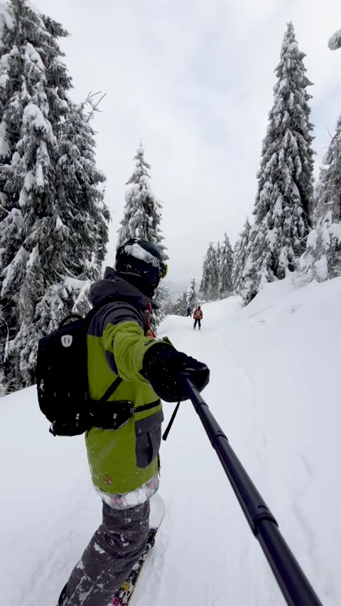 Man taking selfie video while snowboarding Stock Footage 167954582