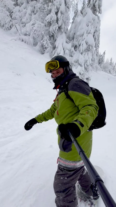 Man taking selfie video while snowboarding Stock Footage 192402541