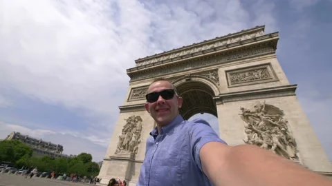 Man taking selfie with a view on Arc de Triomphe in Paris in 4k slow motion Stock Footage 88784164