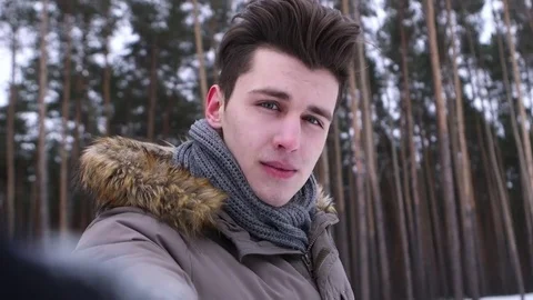 Man taking a selfie in a winter forest under the snow Stock Footage 70988419