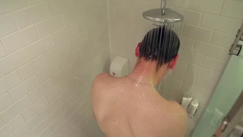 Man taking a shower Stock Footage 76479595