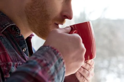 Man taking sip from cup. Stock Photos