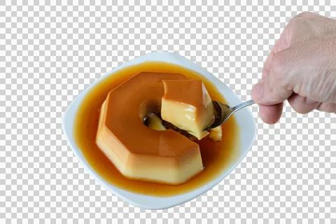 Man taking a slice with a spoon of condensed milk pudding with caramel sauce, Stock Photos