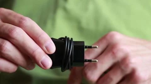 Man taking up smartphone power adapter 動画素材 64621360