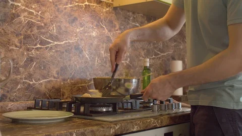A man taking a sticky pancake from a pan Stock Footage 128920287