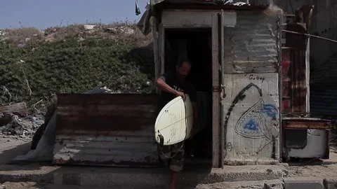 Man taking the surfboard and walking to the beach Stock Footage 148619672