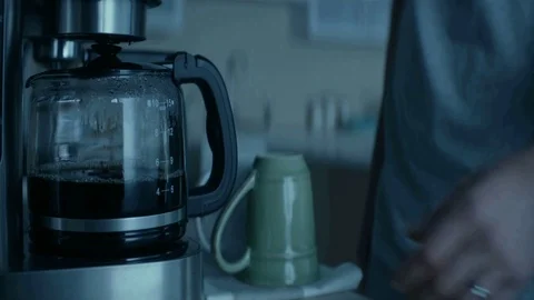 Man taking tea/coffee in a cup standing while in kitchen in morning Stock-Footage 93924331