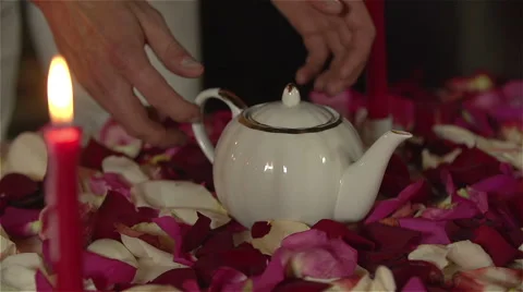 Man taking teapot for romantic tea ceremony. Slow Motion Stock Footage 48950586