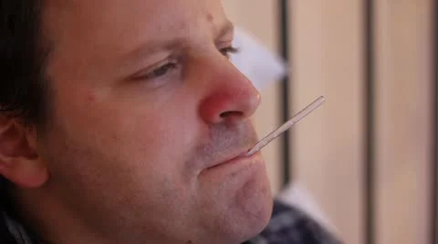 Man taking temperature in bed Stock Footage 20601287