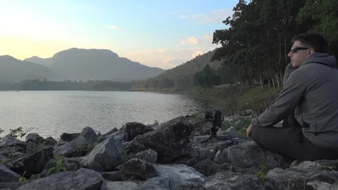 A man taking time lapse at a lake in Chiang Mai, Thailand Stock Footage 100894018