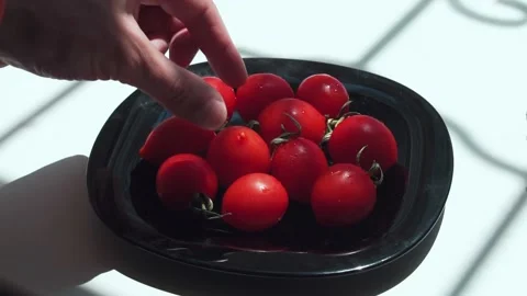 Man taking the tomato from the plate Stock Footage 133344575