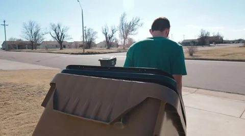 Man Taking Trash Can To Street Stock Footage 53504559