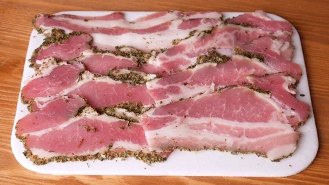 Man taking two slices of bacon. Stock Footage 70878153