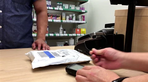 Man taking the UPS parcel and signing on receipt at pharmacy store Stock Footage 67262409