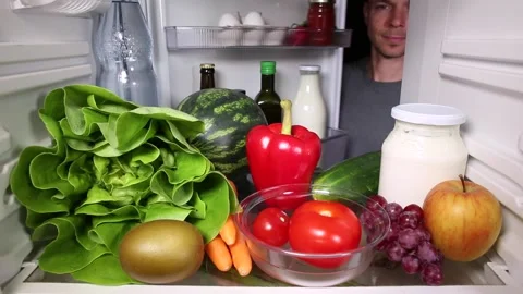 Man taking a vegetable out of the fridge Video stock 135381552