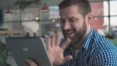 Man taking video call by tablet, portrait, in cafe, close steadycam shot Vídeo Stock 72952172