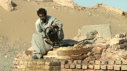 Man taking water from a underground storage Stock Footage 202242823