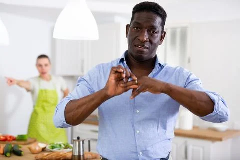 Man taking off wedding ring during quarrel with wife Foto stock