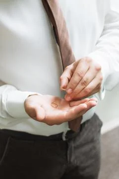 Man is taking off the wedding ring Stock Photos
