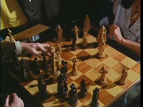 Man taking a white bishop with a black pawn during chess game, 1970s Stock Footage 64629947