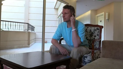 Man talk smartphone, accidentally drop it on floor. Stock Footage 79222382