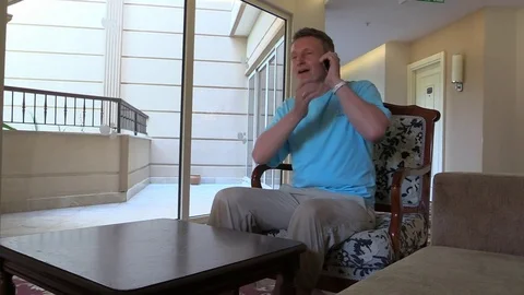 Man talk smartphone and almost drop it but catche at last moment Stock Footage 79222386