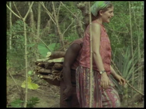 Man talking about rainforest while villagers planting plants, 1990 Stock Footage 136672703