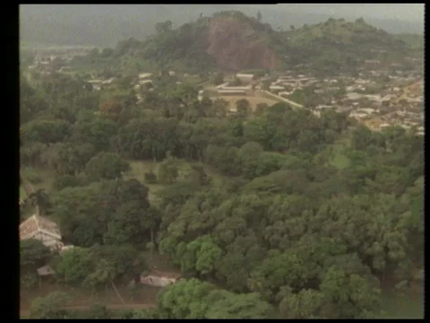 Man talking about town with rainforest and plants, 1990 Stock Footage 136673580