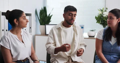 Man, talking and group therapy for counseling session, employee conflict and Stock Footage 321856454