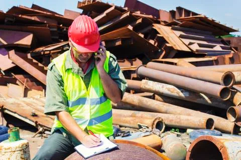 Man talking and write it down on junkyard Stock Photos