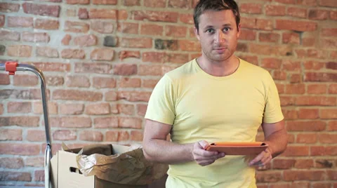 Man talking to the camera and showing a flat Video stock 33737121