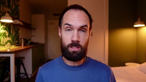 Man Talking to Camera in Cozy Home Interior – Horizontal Video Stock Footage 292968765