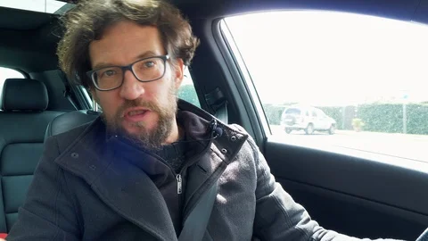 Man talking to camera video phone call driving car closeup Stock Footage 87576143