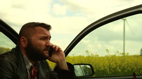 Man talking in the cell phone, sitting in car  Stock Footage 62861290