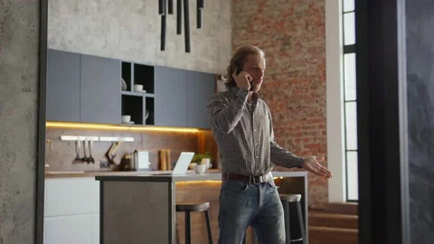 Man talking on cellphone in loft apartment Stock Footage 140934596