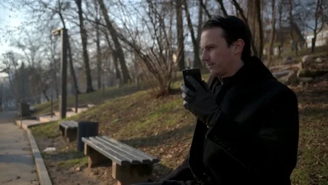 Man talking on cellphone in park 库存影片 83922766