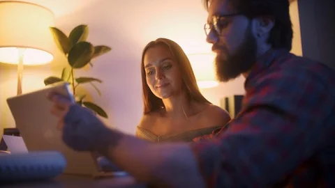 Man Talking To Client With Laptop And Tablet. Cheerful Young Woman Approves a Stock Footage 128022753