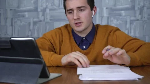 Man talking to clients via video call via tablet Stock Footage 146403945