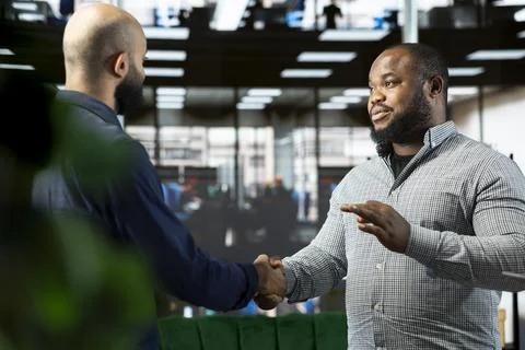 Man talking to director to explain startup evolution vision, doing handshake Stock Photos
